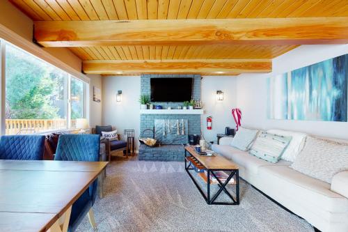 a living room with a couch and a fireplace at Hemlock Haven in Lake Arrowhead