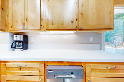 a kitchen with wooden cabinets and a stove at Hemlock Haven in Lake Arrowhead