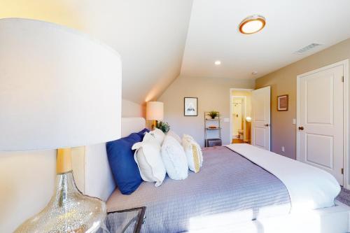 a bedroom with a bed with blue and white pillows at Hemlock Haven in Lake Arrowhead