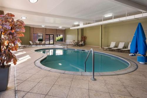 a pool in the middle of a room with tables and chairs at Best Western Pocatello Inn in Pocatello