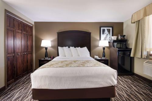 a hotel room with a large bed and two lamps at Best Western Weston Inn in West Yellowstone