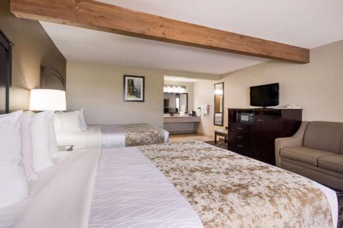 a hotel room with two beds and a television at Best Western Weston Inn in West Yellowstone