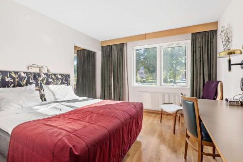 a bedroom with a bed and a table and a dining room at Best Western Hotel Norra Vattern in Askersund
