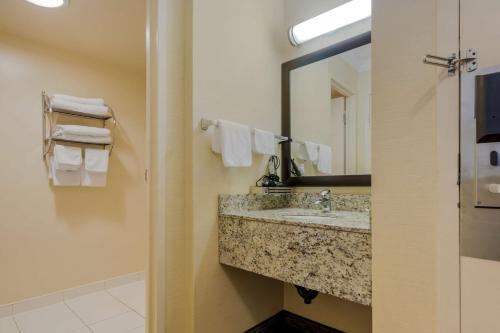 a bathroom with a sink and a mirror and towels at Best Western Plus Dryden Hotel and Conference Centre in Dryden