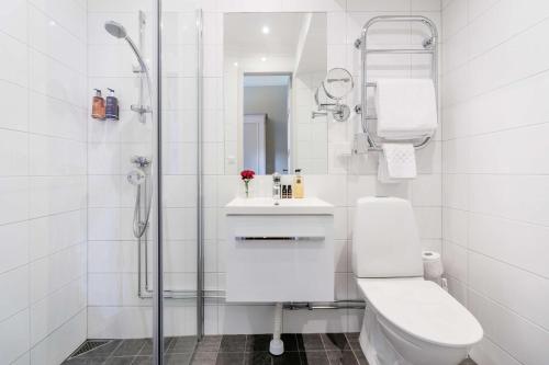 a bathroom with a shower and a toilet and a sink at Hotel Esplanade; Sure Hotel Collection by Best Western in Stockholm