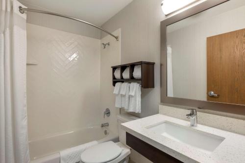 a bathroom with a sink and a toilet and a mirror at Best Western Watertown Inn & Suites in Watertown