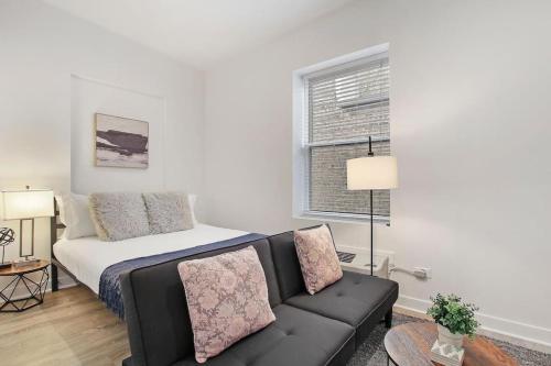 a living room with a couch and a bed at Studio Apt with Laundry, Near Shops! - Montrose Studio rep in Chicago