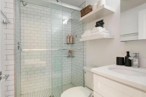 a bathroom with a shower and a toilet and a sink at Studio Apt with Laundry, Near Shops! - Montrose Studio rep in Chicago