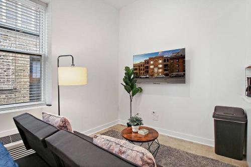 a living room with a couch and a table at Studio Apt with Laundry, Near Shops! - Montrose Studio rep in Chicago
