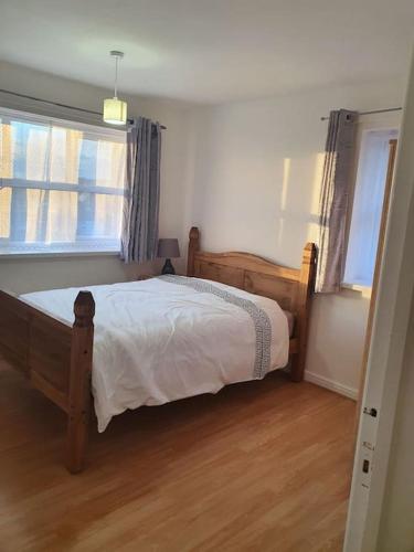 a bedroom with a wooden bed and a window at Lovely 2-Bedroom Condo With indoor Fire Place in London