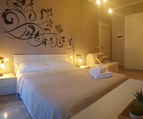 a bedroom with a large white bed with a wall art at B&B Dei Cardinali in Terni