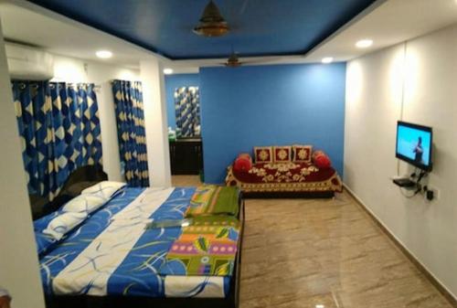 a bedroom with a bed and a flat screen tv at Le Grace Beachview in Chennai