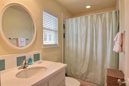 a bathroom with a sink and a mirror and a shower at Basket- Case in Port Aransas