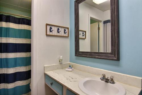 a bathroom with a sink and a mirror at On the Half Shell - Condo in Port Aransas