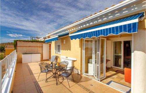 a patio with a table and chairs on a balcony at Amazing Home In Puerto De Mazarrón in Puerto de Mazarrón