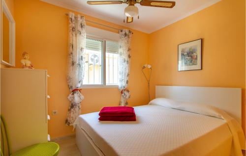 a bedroom with a white bed and a window at Amazing Home In Puerto De Mazarrón in Puerto de Mazarrón