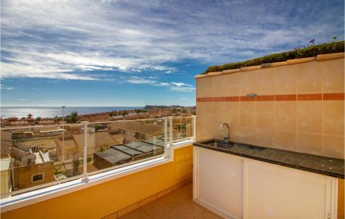 a kitchen with a view of the ocean from a balcony at Amazing Home In Puerto De Mazarrón in Puerto de Mazarrón