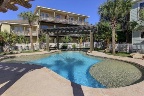a swimming pool in front of a house at Getaway in Port Aransas