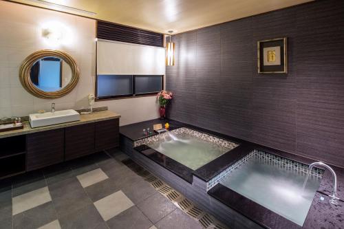 a bathroom with a large tub and a sink at Great Roots Forestry Spa Resort in Sanxia