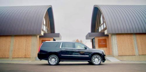 a black suv parked in front of a building at Andaru Collection Niseko in Kutchan