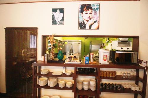 a kitchen with a shelf with plates and appliances at Lodge Q in Hakuba