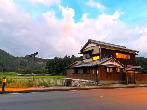 a house on the side of a road with a fence at Villa KUMANO in Hongu