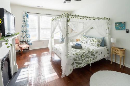 a bedroom with a white bed with a canopy at Garden Penthouse in RVA! 3 Bedroom, 3 Bath! in Richmond