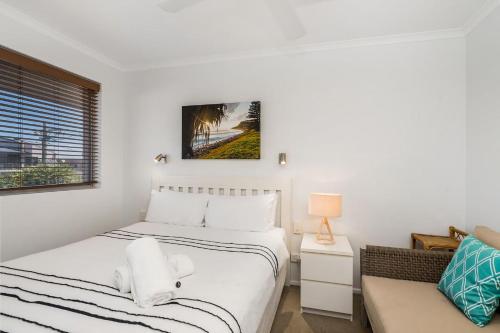 a bedroom with two beds and a couch at Apartment 8T in Lennox Head