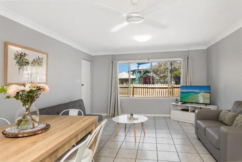 a living room with a couch and a table at Apartment 5B in Lennox Head