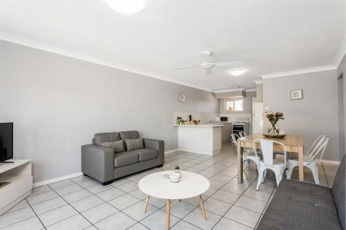 a living room with a couch and a table at Apartment 5B in Lennox Head