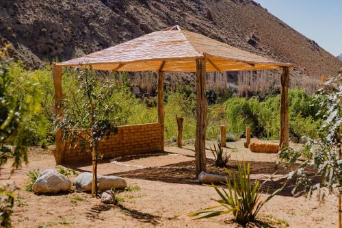 a pavilion in the middle of a garden at Piuquenes Lodge - Cabañas, Viñedos y estrellas en Horcón, Valle de Elqui in Horcon