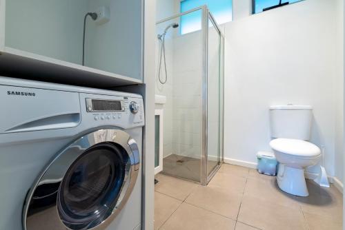 a washing machine in a bathroom with a toilet at Studio Apartment - 5 Minutes to Hobart CBD - Free Parking - Free WIFI in Sandy Bay