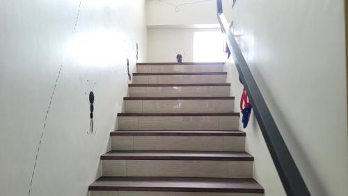 a staircase in a house with brown stairs and an umbrella at ChaoPingJia Fengge Guesthouse in Wujie
