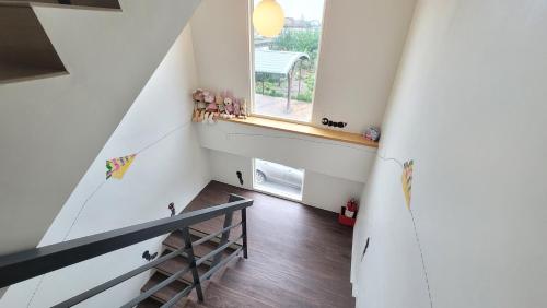 a staircase in a house with a window at ChaoPingJia Fengge Guesthouse in Wujie
