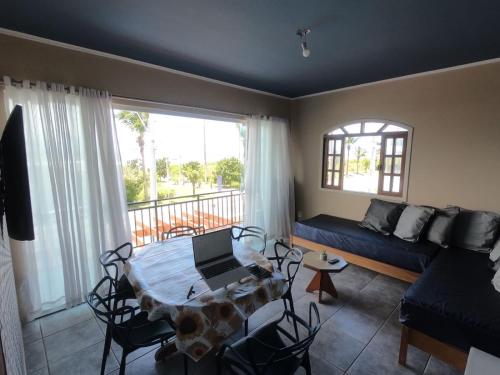 a living room with a table and a couch at Apto Frente para o Mar in Pontal do Paraná