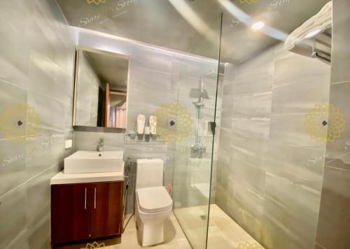 a bathroom with a toilet and a sink and a mirror at Affable 1BR Service Apartment 2px allows 5Px 19088 in Manila