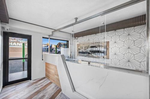a kitchen with a white counter and a window at Hotel OPUS Bronx Near Bay Plaza Mall in Bronx