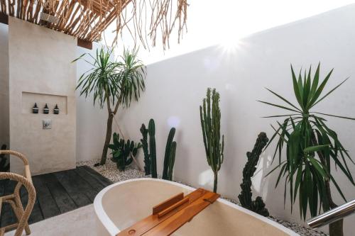 a room with a table and some plants at Amaka Villas in Uluwatu