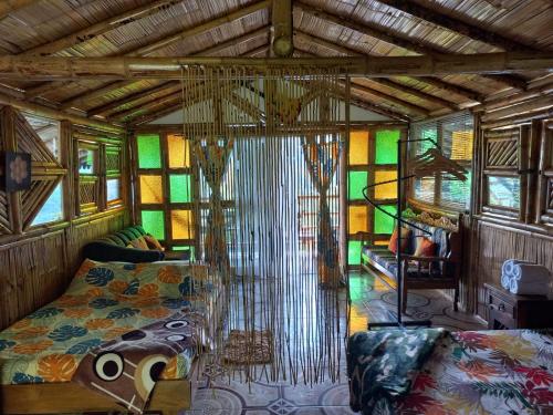 a bedroom with a bed in a room with stained glass at Cabaña LuzMi Cocorná in Cocorná
