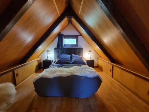 a bedroom with a large bed in a attic at Chalet Saint-Michel-de-Chaillol, 4 pièces, 6 personnes - FR-1-393-159 in Saint-Michel-de-Chaillol