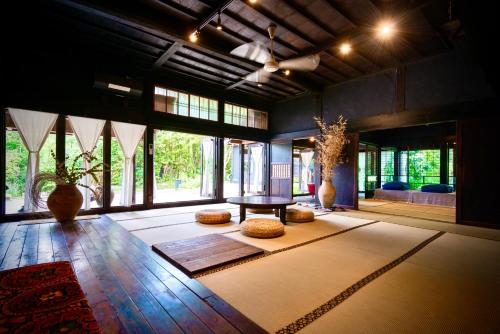 a large room with a table and some windows at Traditional house, Blue moon villa, 古民家 蒼月庵 in Kimitsu