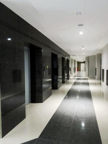 a hallway of a building with black walls and white floors at FORMOSA RESIDENCEN - The Apartments 2 Bed Room in Nagoya