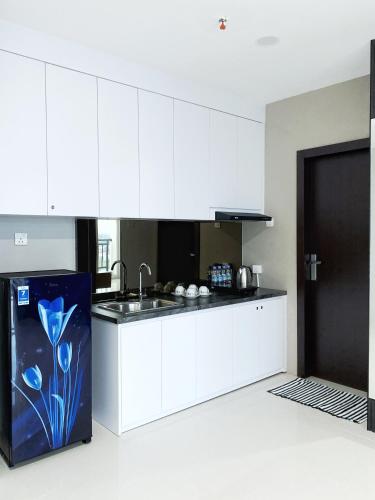 a kitchen with white cabinets and a blue flower painted on the counter at FORMOSA RESIDENCEN - The Apartments 2 Bed Room in Nagoya