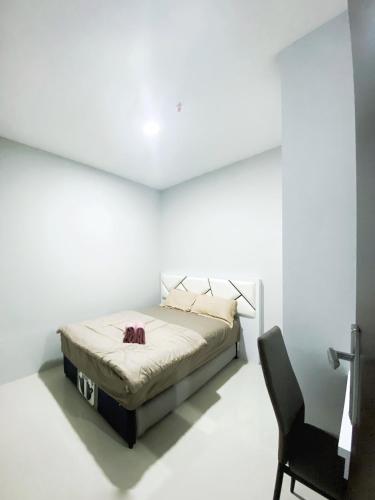 a white room with a bed and a chair at FORMOSA RESIDENCEN - The Apartments 2 Bed Room in Nagoya