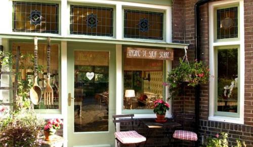 a music store with two benches in front of it at Villa Warempel in Valkenburg