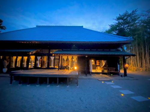 a building with a blue roof and a patio at Traditional house, Blue moon villa, 古民家 蒼月庵 in Kimitsu