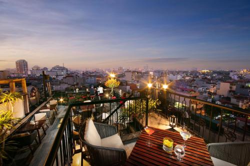 a balcony with a view of a city at night at HOTEL du LAC Hanoi in Hanoi