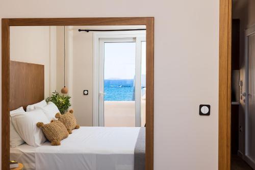 a bedroom with a bed with a view of the ocean at Almi of Naxos in Naxos Chora