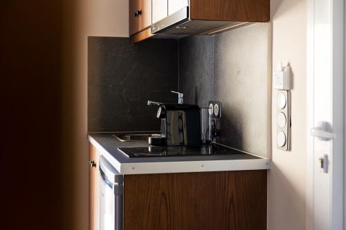 a kitchen with a sink and a coffee maker at Almi of Naxos in Naxos Chora