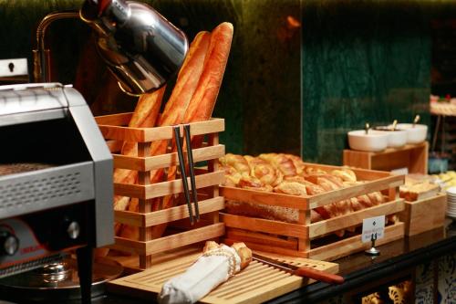 a display of bread and pastries on a counter at HOTEL du LAC Hanoi in Hanoi